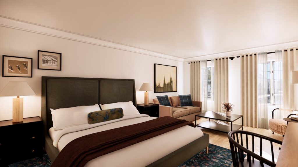 A modern hotel room with a king-size bed, bedside tables with lamps, a sofa, coffee table, desk, and large windows with curtains allowing natural light in.