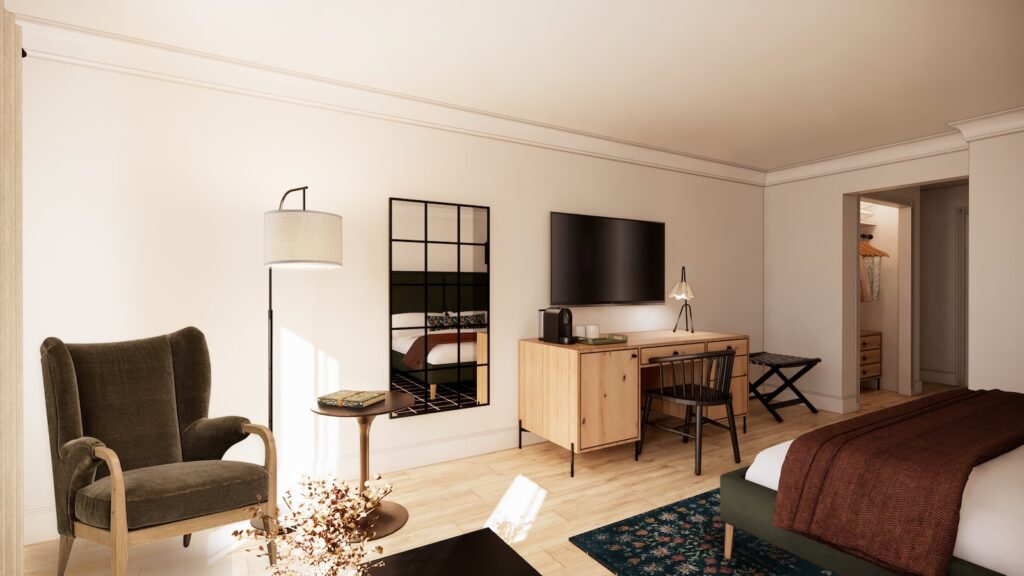 Modern hotel room with a bed, armchair, floor lamp, desk, TV, mirror, and open closet visible in the background.