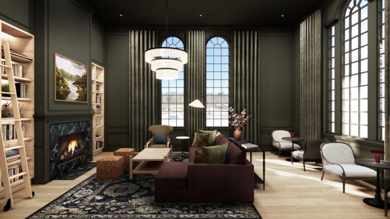 Modern living room with large arched windows, dark green walls, a fireplace, bookshelves, a maroon sofa, armchairs, pendant lights, and a patterned rug.